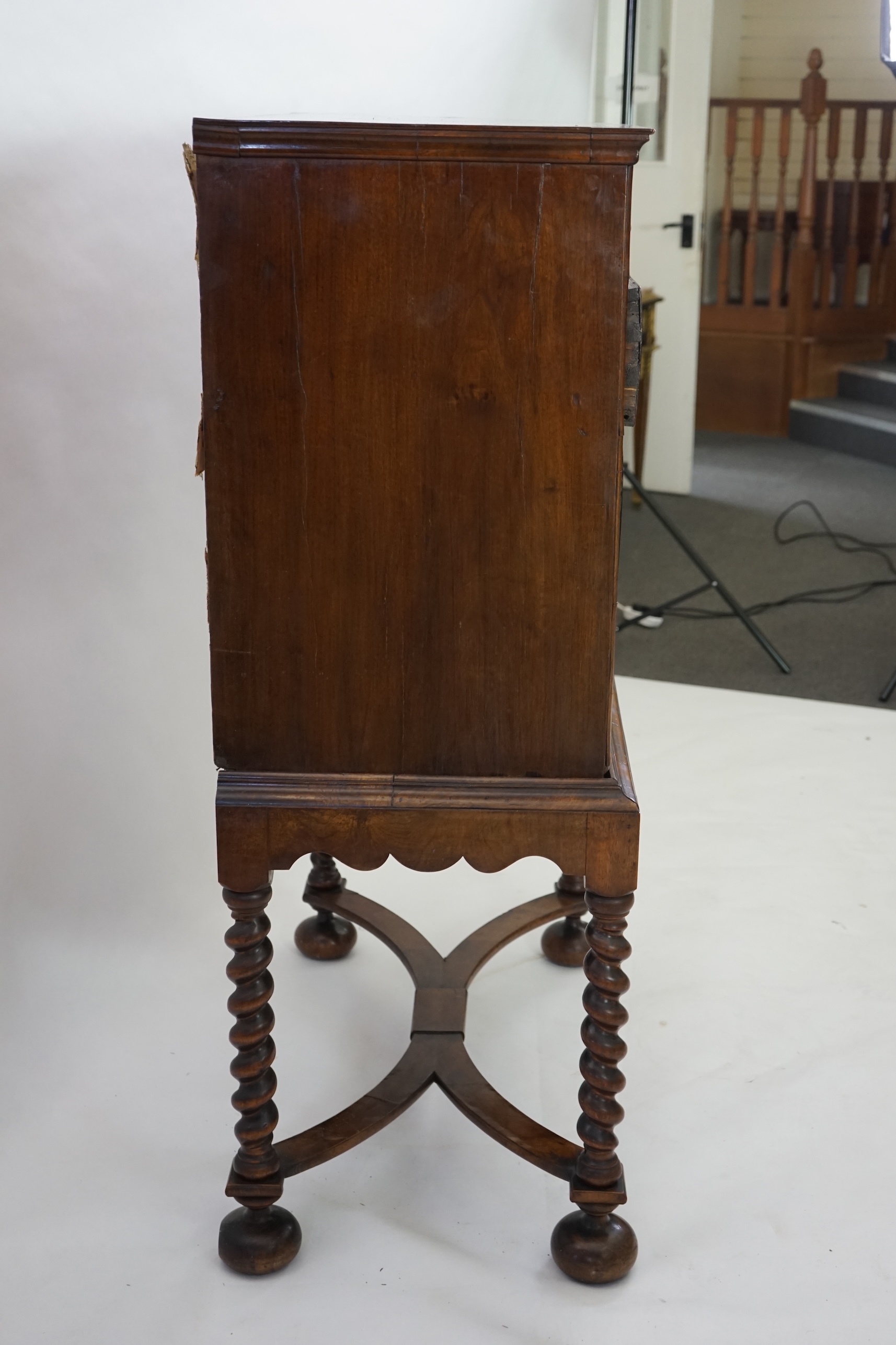 An early 18th century and later crossbanded walnut chest on stand